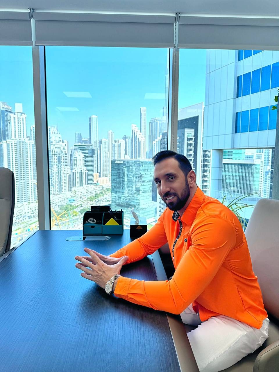 Insight City founder at the office with Dubai skyline